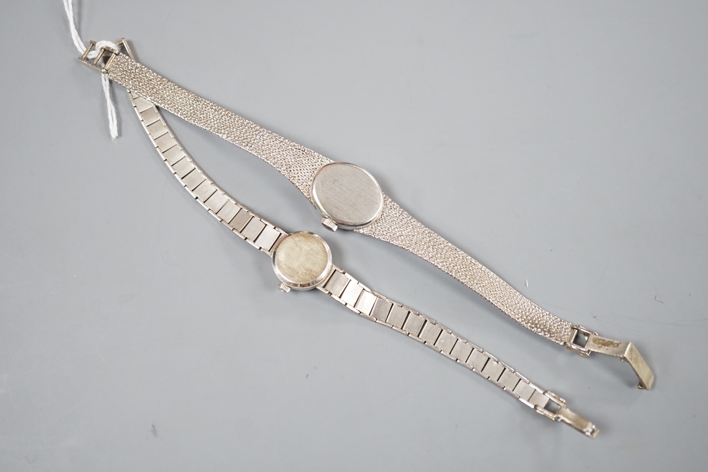 A lady's 9ct white gold Rotary manual wind wrist watch and a similar Omega wrist watch, gross 31.5 grams.